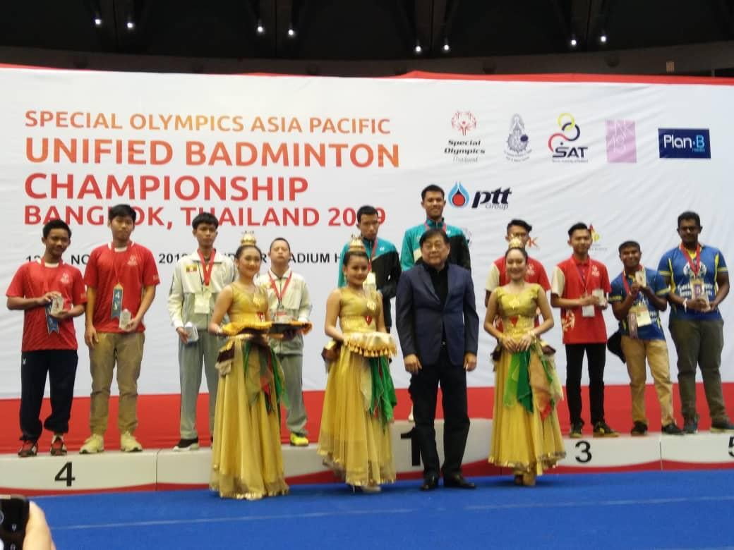 Special Olympics Malaysia Unified Badminton Team receiving medal